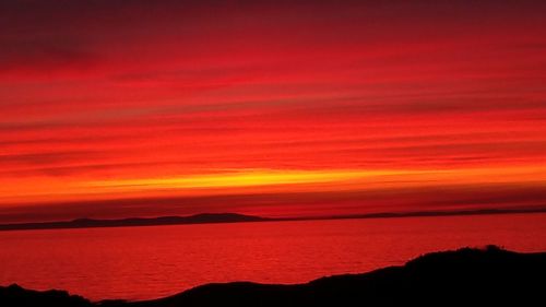 Scenic view of sea against romantic sky at sunset