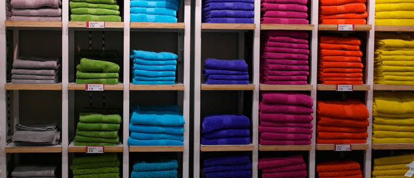 Full frame shot of colorful clothes in shelves at shop for sale