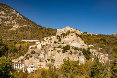 View of buildings against clear blue sky