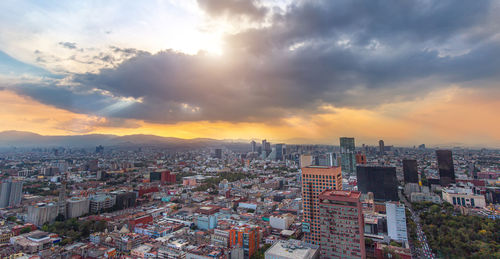 High angle view of buildings against sky during sunset