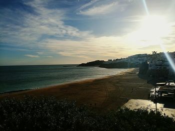 Scenic view of beach against sky during sunset
