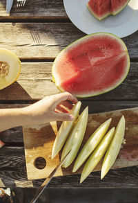 High angle view of hand holding fruit on table