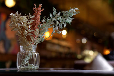 Modern dried flower arrangement in a glass vase with on brown background. boho style, cozy evening