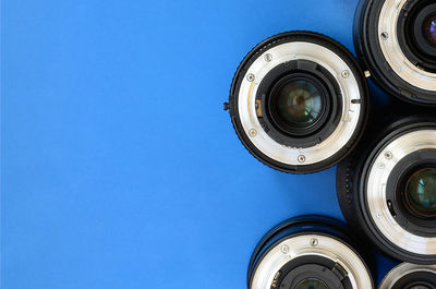Directly above shot of various lenses on blue background