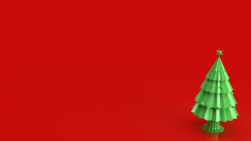 Low angle view of illuminated building against red background