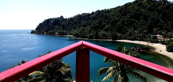 Scenic view of swimming pool by sea against sky