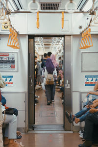 Walking on the train people use public trains to speed up their activities.