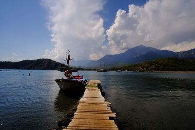 Pier over lake against sky