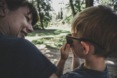 Portrait of mother and son siting in park