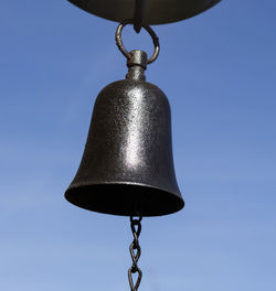 Close-up of metal chain against clear blue sky