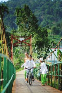 People sitting on bridge