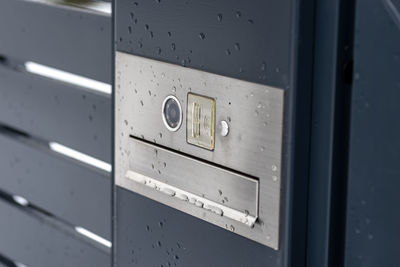 A modern videophone with a letterbox and a wireless card reader, mounted in panel fence