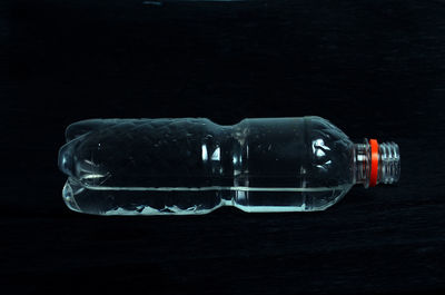 Close-up view of bottle against black background