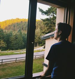 Man looking through window