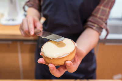 Midsection of man holding ice cream