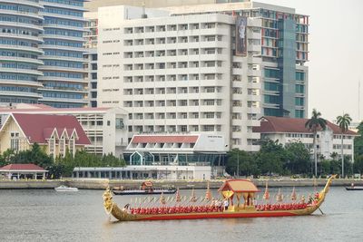 Buildings by river in city