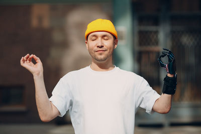 Full length portrait of young man standing outdoors