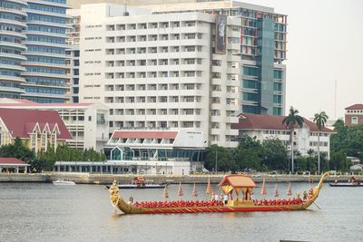 Buildings by river in city