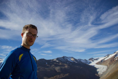 Portrait of man standing against mountains
