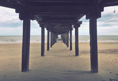 Scenic view of beach and pier against sky