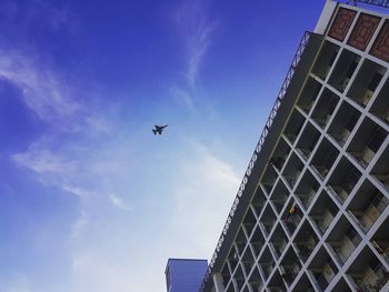 Low angle view of airplane flying in sky