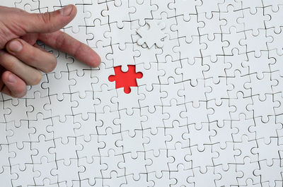 Cropped hand gesturing on jigsaw puzzle