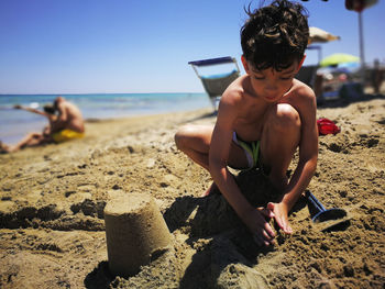 Shirtless boy on beach