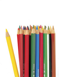 High angle view of multi colored pencils against white background