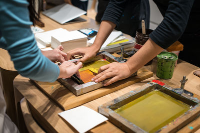 Close-up of people on table