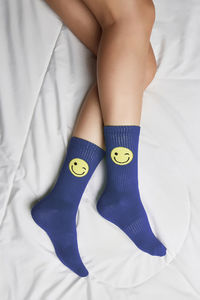 Low section of child legs on bed