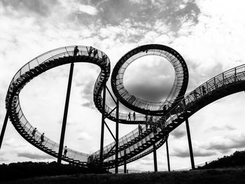 Low angle view of rollercoaster against sky