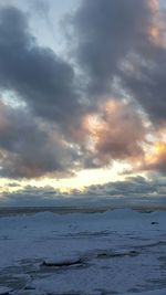 Scenic view of beach against sky during sunset