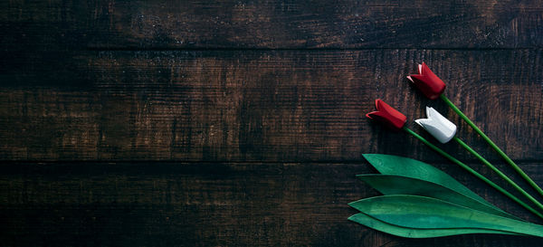 Close-up of red wooden tulip or rose on table