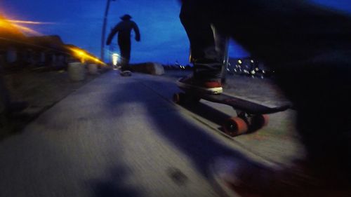 Blurred motion of people on road at night