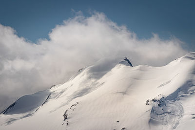 Scenic view of snow covered mountain against sky