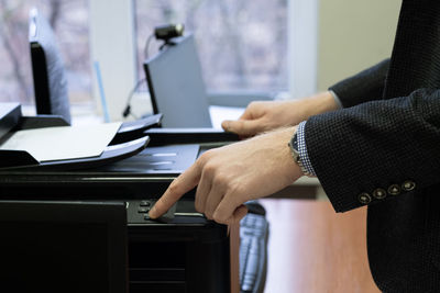 Midsection of businessman working in office