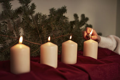 Hand lighting advent candle