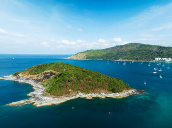 Drone aerial view shot of tropical sea with beautiful small island in phuket thailand