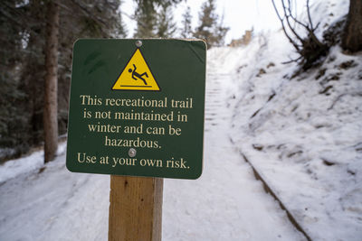 Close-up of warning sign outdoors in snow