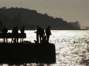 Silhouette of people at sunset