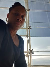 Portrait of young man looking through window