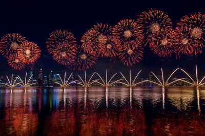 Firework display over river at night