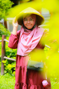 Portrait of young woman using mobile phone