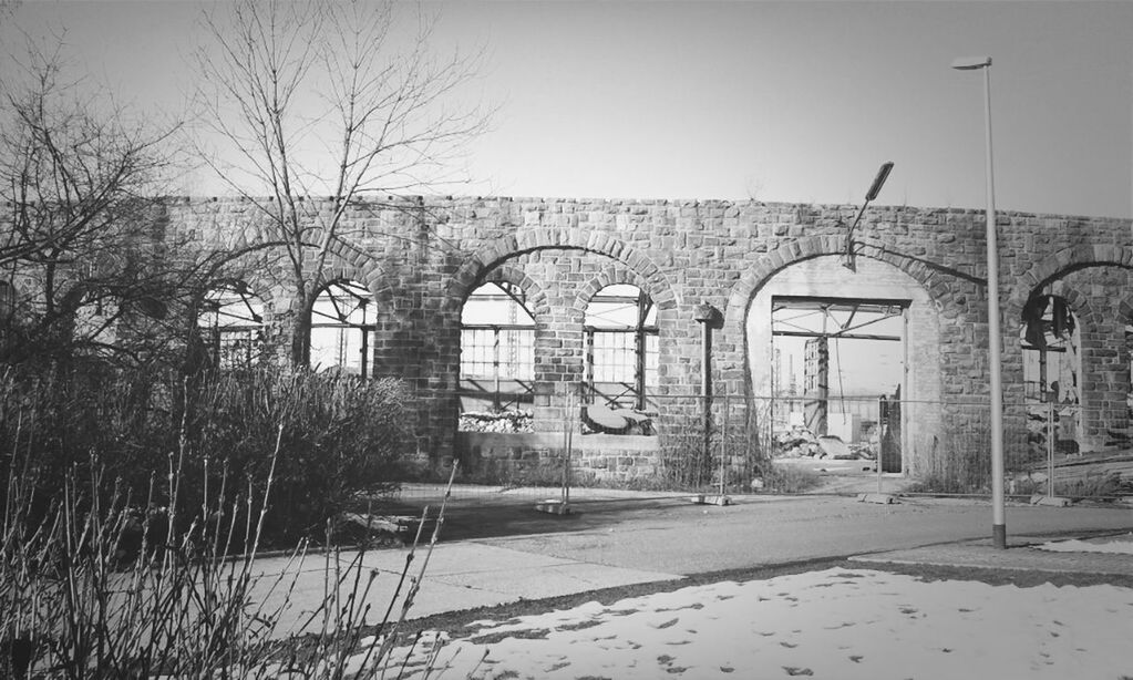 built structure, architecture, building exterior, tree, clear sky, bare tree, house, day, no people, abandoned, outdoors, sky, old, nature, wall - building feature, building, arch, gate, residential structure, text