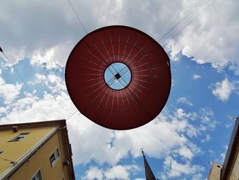 Low angle view of lampshade against sky in city