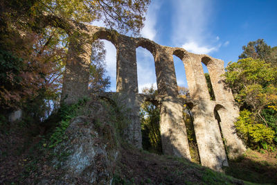 Ruins of roman aqueduct located in ancient monterano,canale monterano,italy.view from bottom