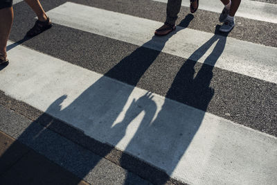 Low section of people walking on road