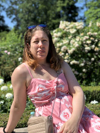 Beautiful young woman sitting in park