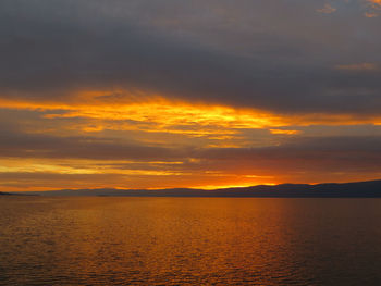 Scenic view of sea against orange sky