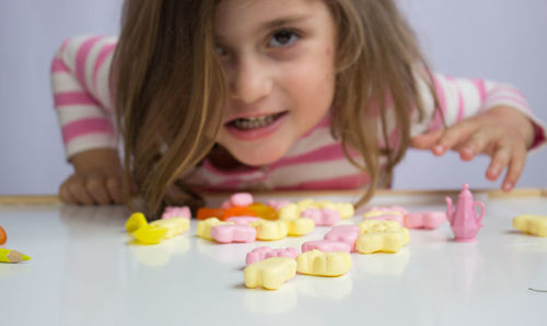 Portrait of smiling girl with ice cream on table